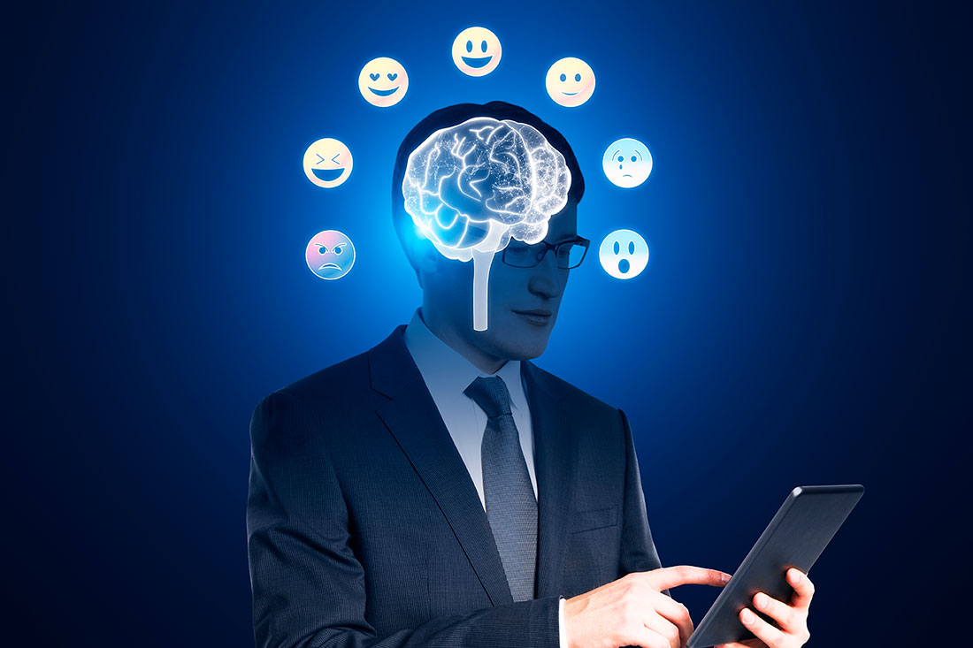 Iconos de cerebro y emociones iluminando el rostro de un hombre sosteniendo una tablet