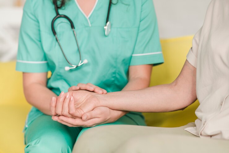 Mano de enfermera sosteniendo la mano de su paciente