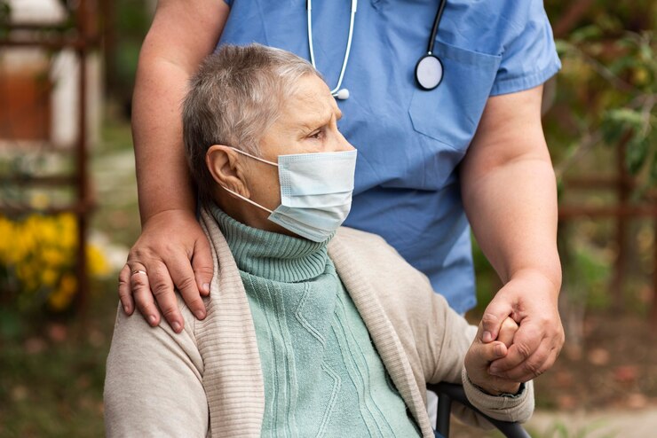 Enfermera cuidando de su paciente Enfermera sosteniendo la mano y abrazando desde atrás a anciana